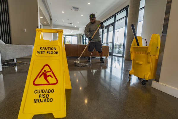 janitor mopping the floor at a commercial building