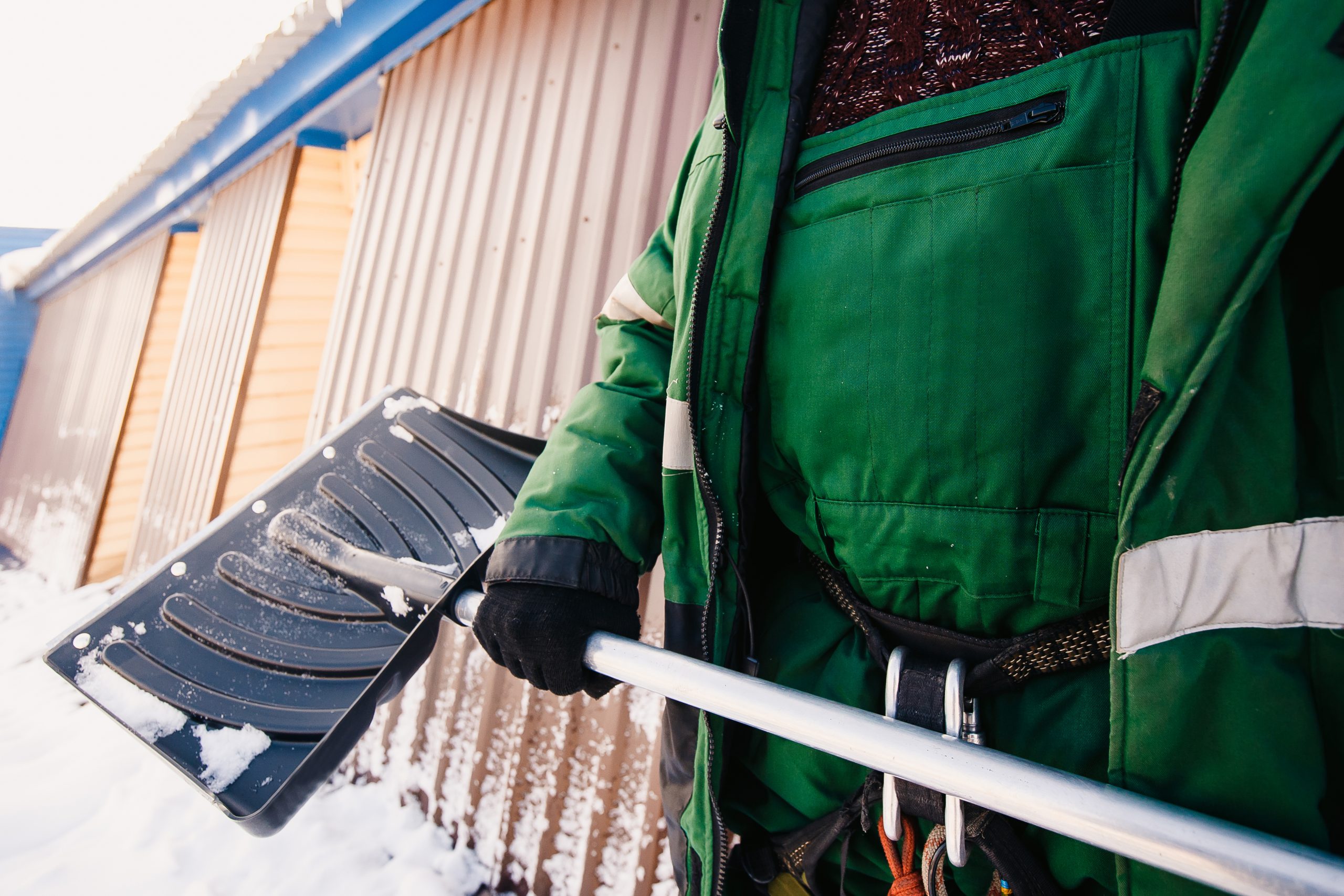 Shovel. Close-up of a shovel for snow cleaning in winter in the hands of a man. Janitorial Technicians on the job