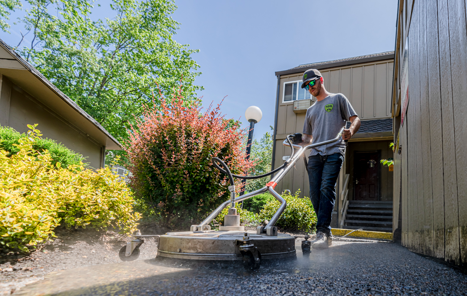 Maintenance Service Technician using equipment to maintain walkways