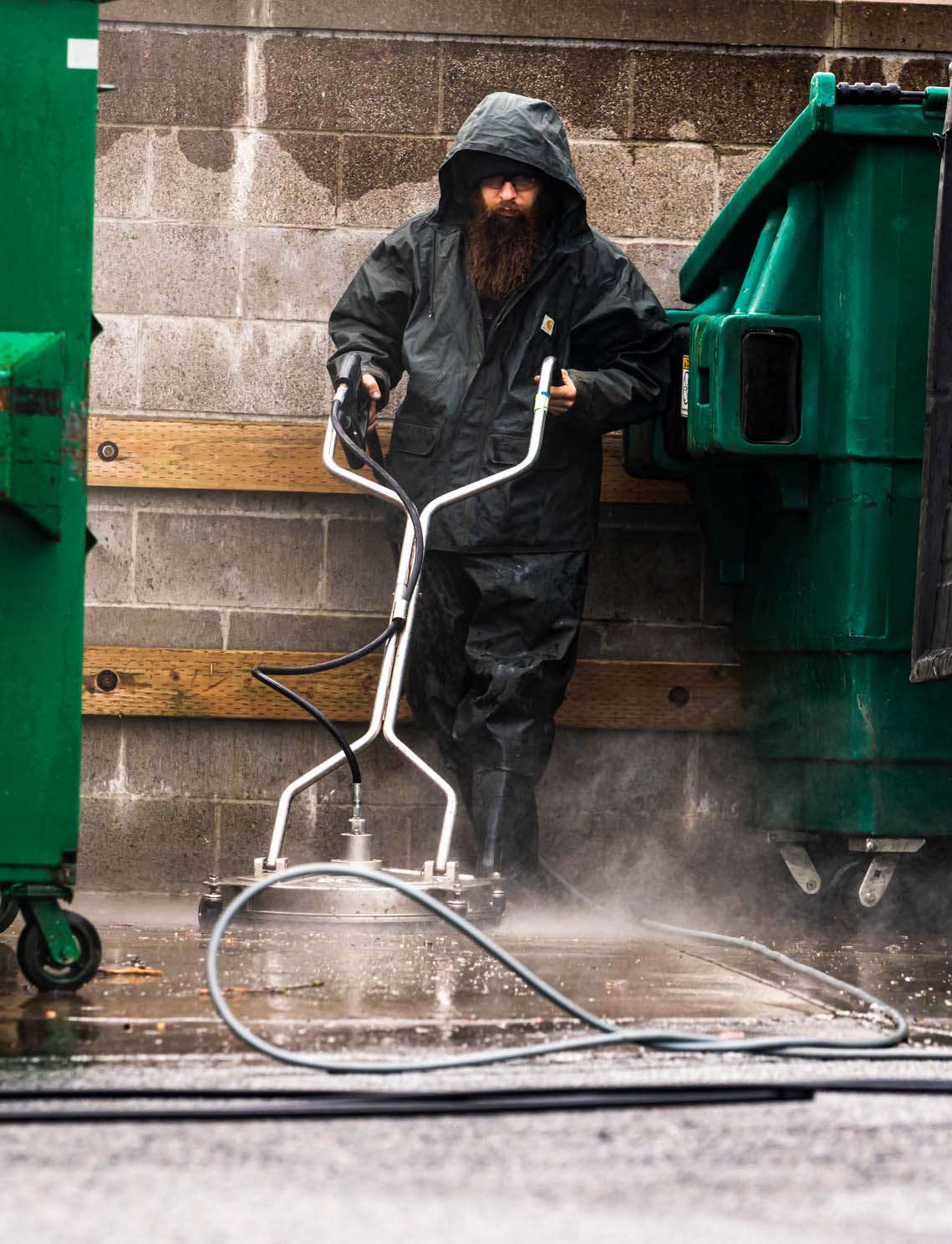 Power washing and floor scrubbing dumpster enclosure