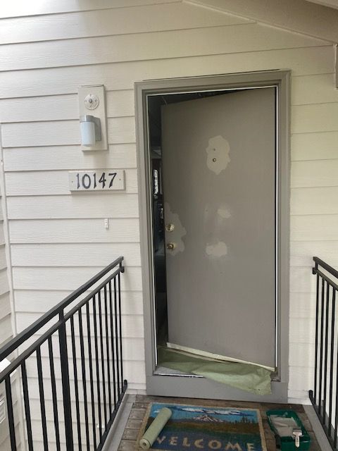 apartment door with peeled off paint