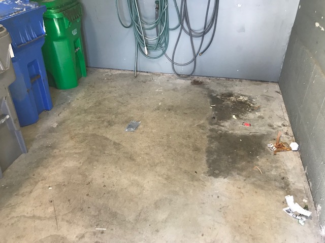 dirty parking garage with stain and trash