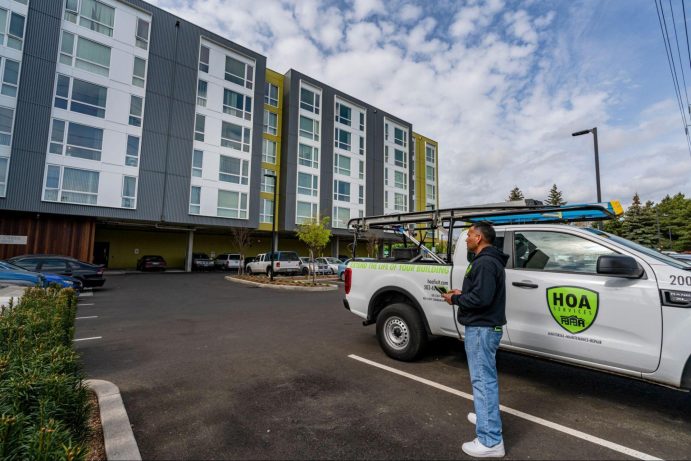 contractor looking at apartment building in portland